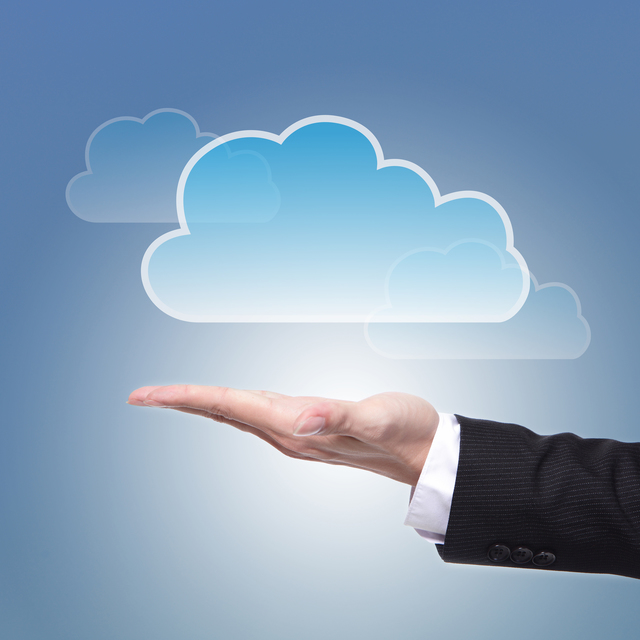 Cloud computing concept with copy space, business man hand palm holding cloud with blue sky background